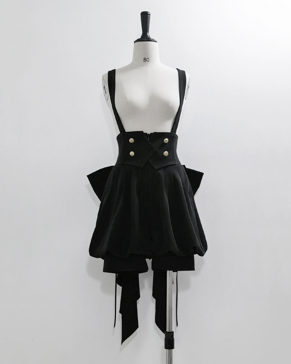 Stylish Black High-Waisted Suspender Shorts with Flared Skirt Overlay