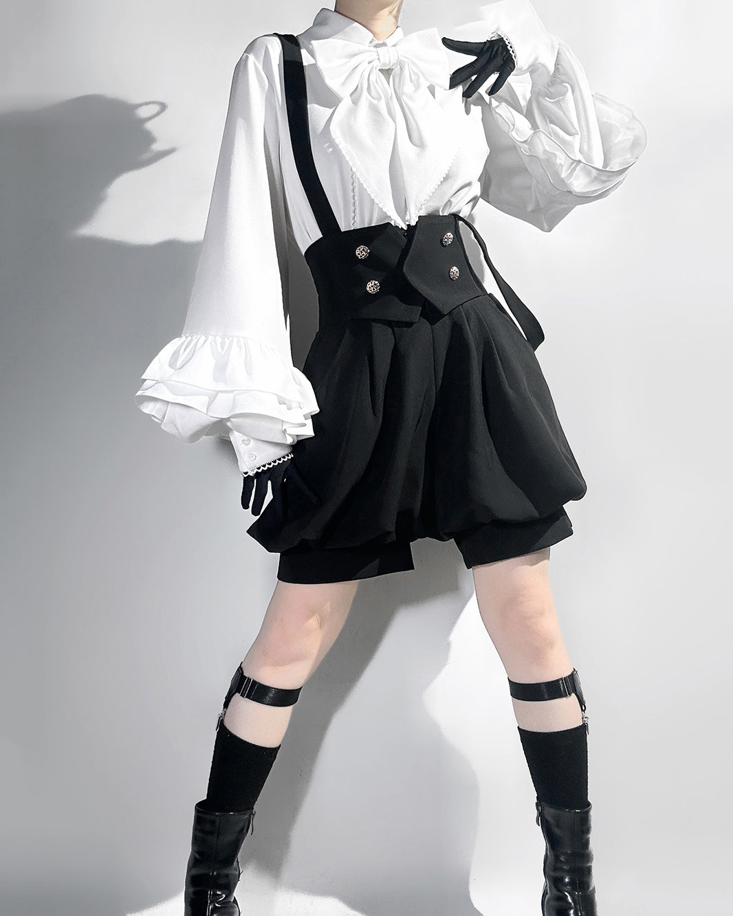 Stylish Black High-Waisted Suspender Shorts with Flared Skirt Overlay