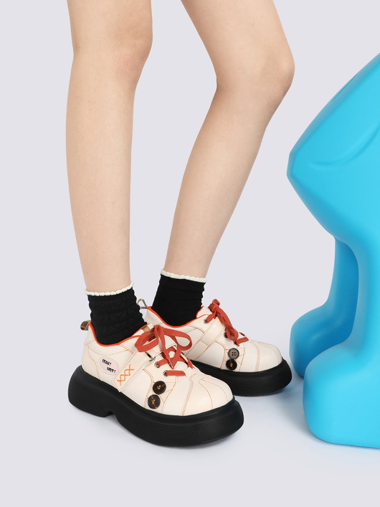 Orange Accents and Buttons Decorative Cream Sneakers